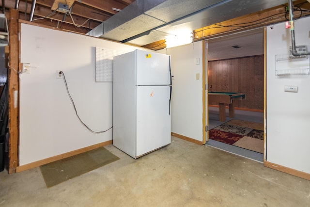 basement featuring white fridge, wood walls, and billiards