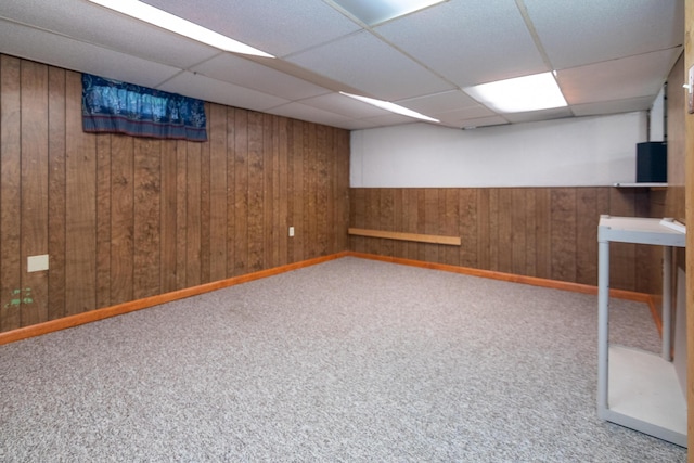 basement with carpet flooring and a paneled ceiling