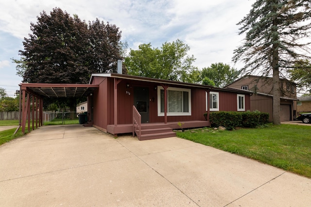 view of front facade with a front yard and a carport