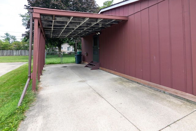 view of car parking featuring a yard and a carport