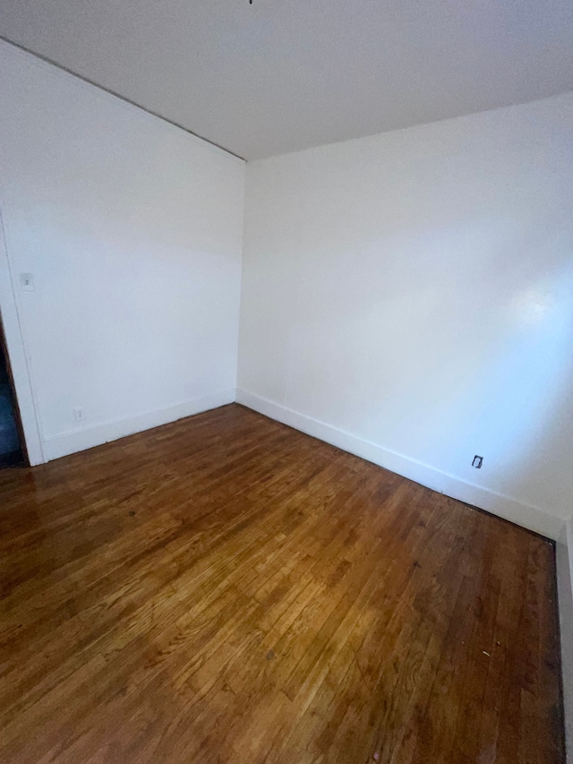 unfurnished room featuring dark hardwood / wood-style floors