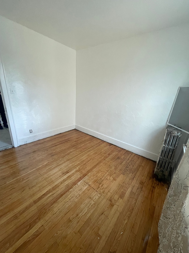 unfurnished room featuring hardwood / wood-style flooring