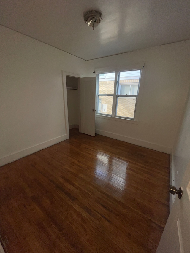 unfurnished room featuring dark hardwood / wood-style flooring