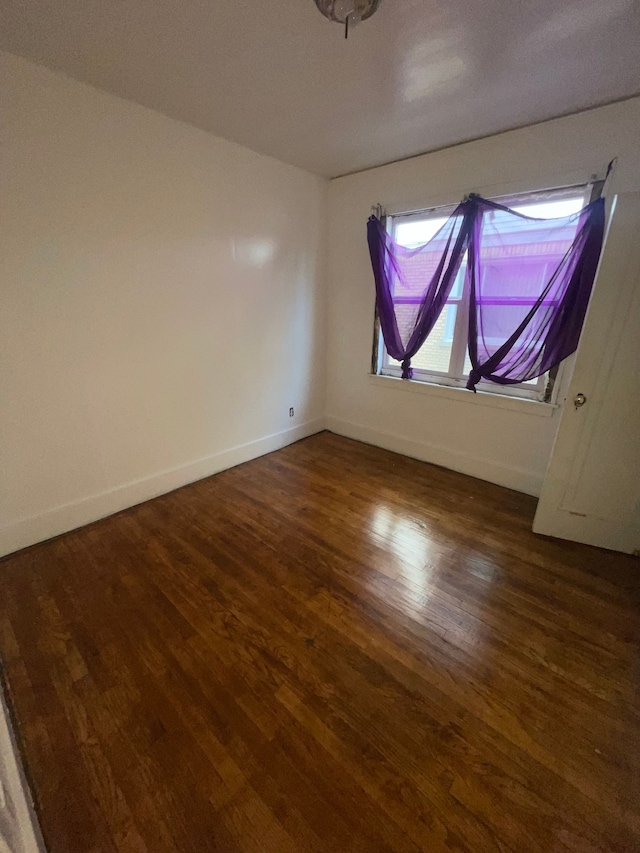 empty room with dark wood-type flooring