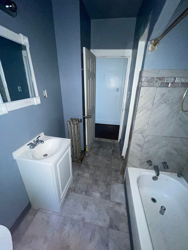 bathroom with a tub to relax in and vanity