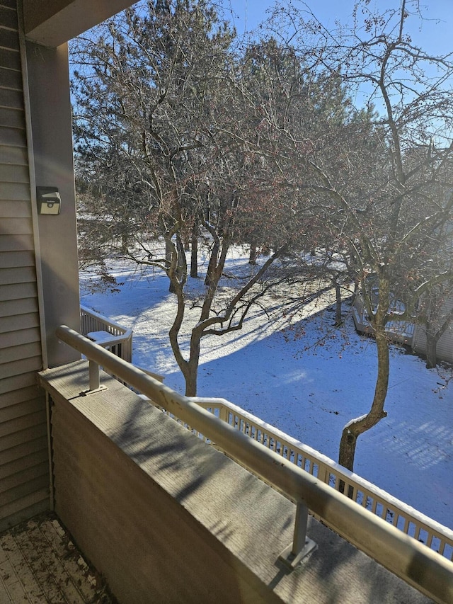 view of snow covered back of property