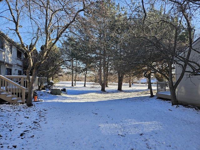 yard layered in snow featuring a wooden deck