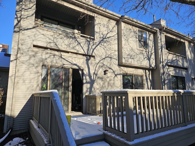 rear view of property featuring a deck