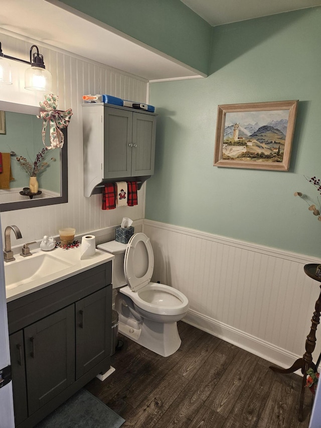 bathroom with hardwood / wood-style floors, vanity, and toilet