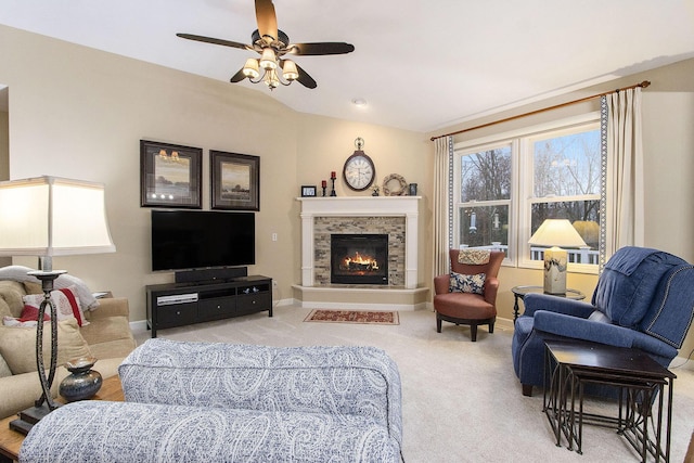 carpeted living room with ceiling fan and a fireplace