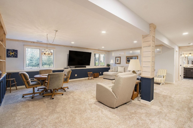 carpeted living room with a wealth of natural light and a notable chandelier