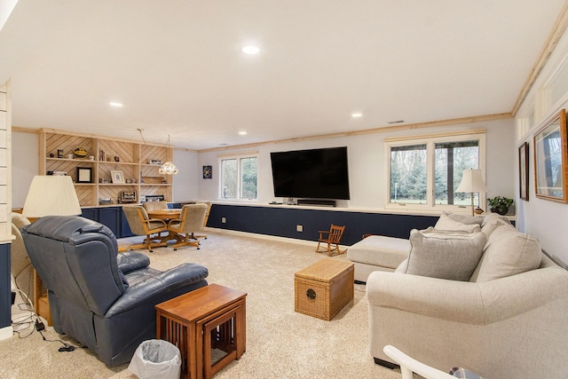 carpeted living room with crown molding and plenty of natural light