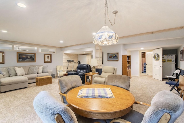 dining area with ornamental molding, light colored carpet, and an inviting chandelier