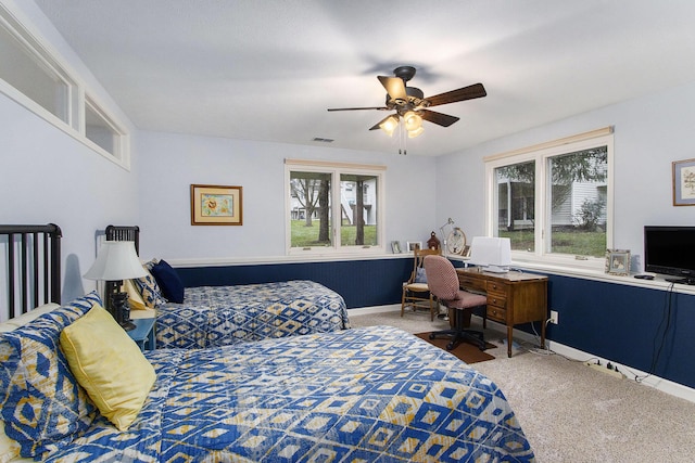 bedroom with carpet flooring, ceiling fan, and multiple windows