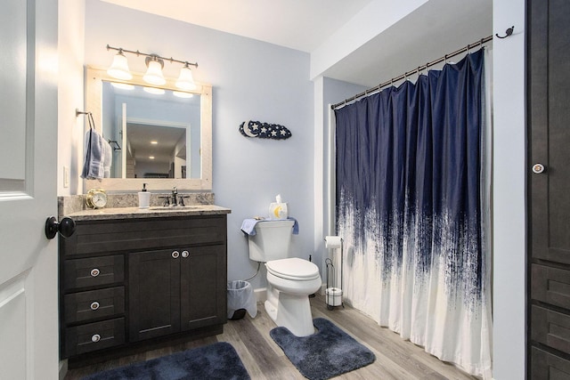 bathroom featuring hardwood / wood-style flooring, vanity, toilet, and a shower with shower curtain