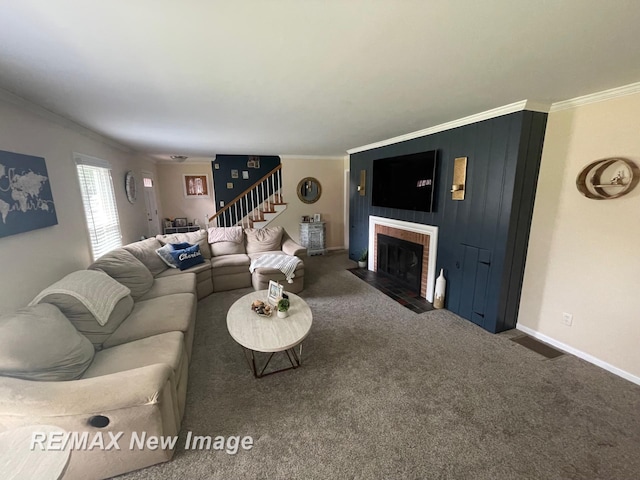 living room featuring dark colored carpet, ornamental molding, and a fireplace