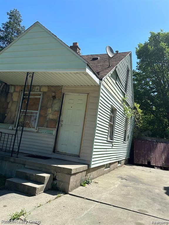 19664 Fleming St, Detroit, MI 48234 - view of front of property with a chimney and a shingled roof
