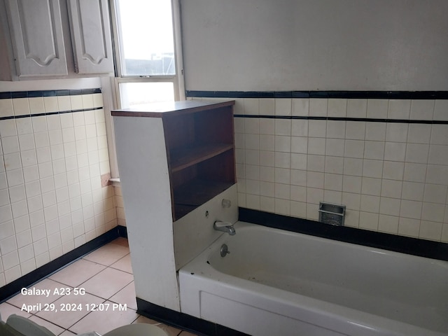 1872 Commerce St, Muskegon, MI 49441 - full bath with tile walls, a bathtub, and tile patterned flooring