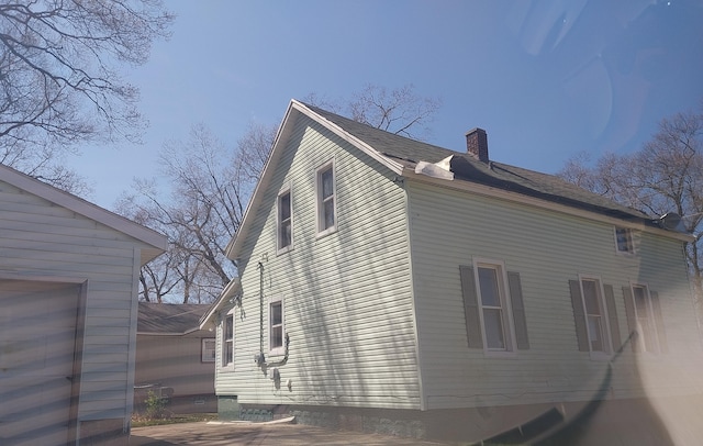 1872 Commerce St, Muskegon, MI 49441 - view of property exterior featuring a chimney