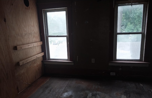 1872 Commerce St, Muskegon, MI 49441 - spare room with wood-type flooring and healthy amount of natural light