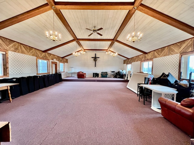 living room with vaulted ceiling with beams, ceiling fan with notable chandelier, and carpet floors