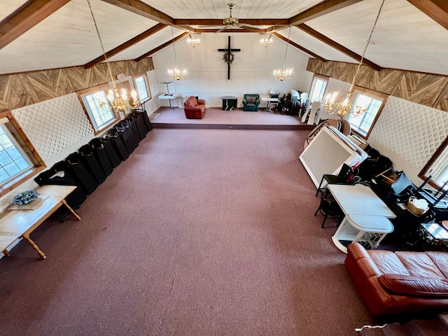 additional living space featuring carpet, vaulted ceiling with beams, and ceiling fan with notable chandelier