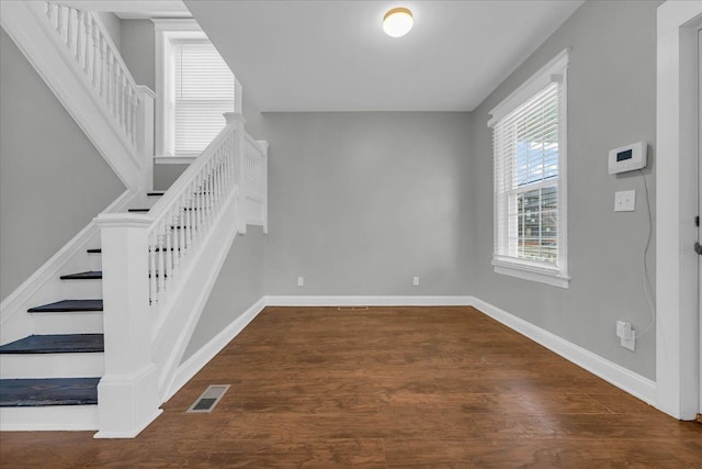 stairway with hardwood / wood-style floors