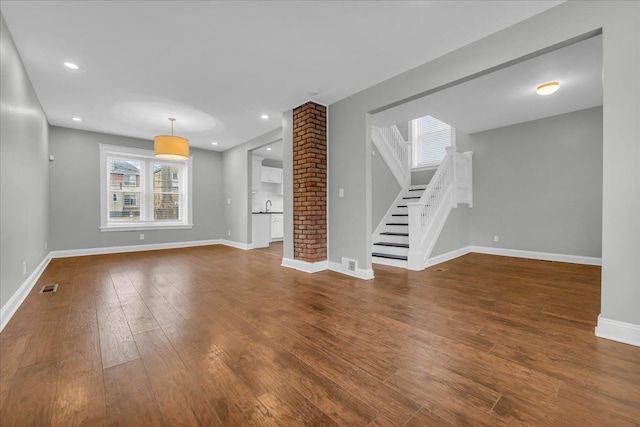 unfurnished living room featuring hardwood / wood-style floors