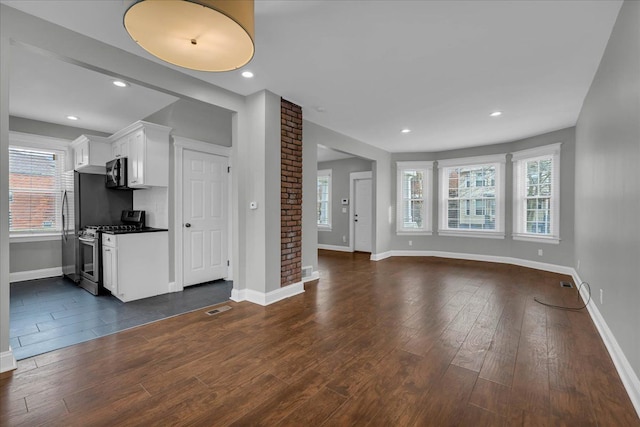 unfurnished living room featuring dark hardwood / wood-style flooring