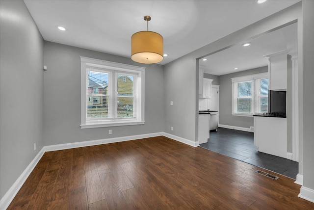 unfurnished living room featuring dark hardwood / wood-style floors