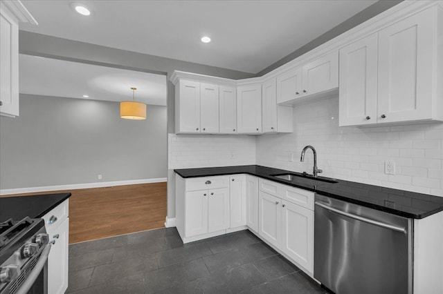 kitchen with backsplash, stainless steel appliances, sink, decorative light fixtures, and white cabinets