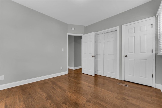 unfurnished bedroom featuring dark wood-type flooring