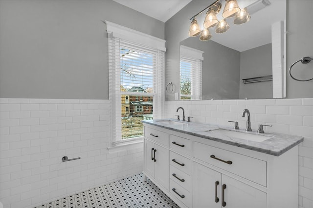 bathroom featuring tile patterned flooring, vanity, and tile walls