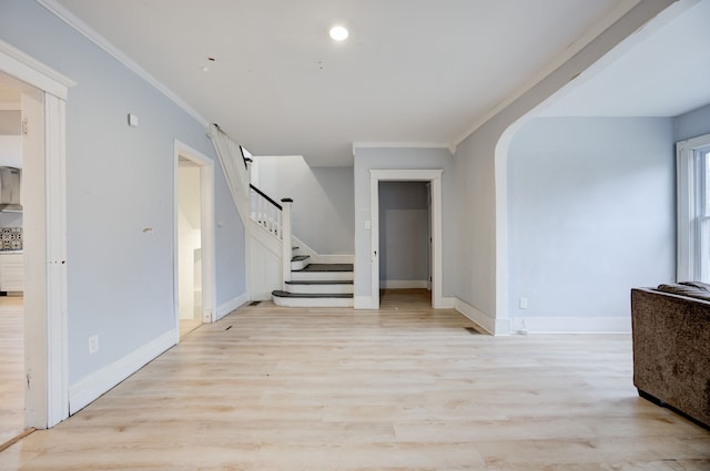 interior space with crown molding and light hardwood / wood-style flooring