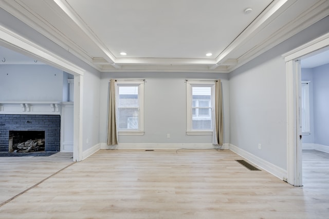 unfurnished living room with light hardwood / wood-style flooring, a brick fireplace, and crown molding