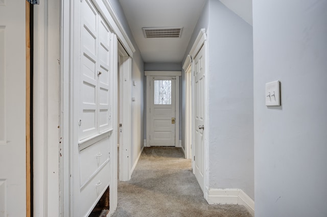 hallway featuring light carpet