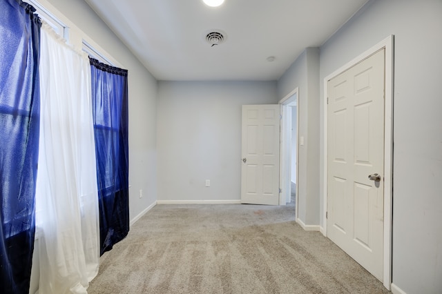 spare room with light colored carpet