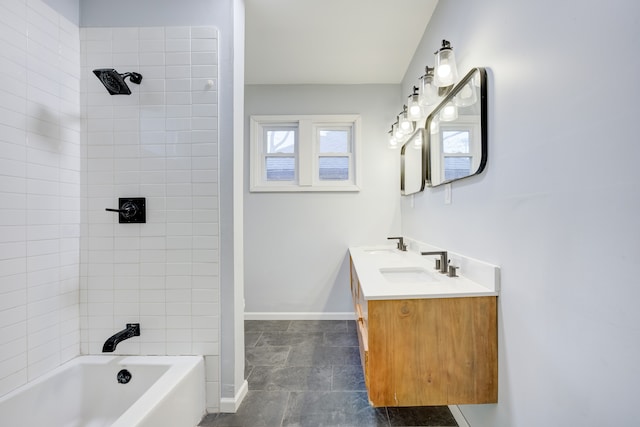 bathroom featuring tiled shower / bath combo and vanity