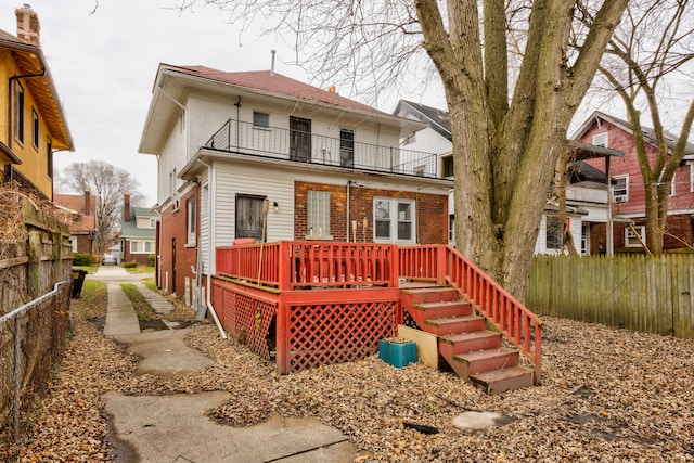 rear view of house with a balcony and a deck