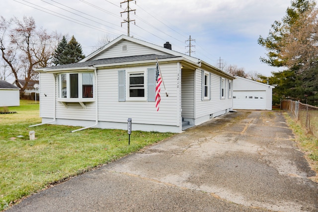 view of front of house with a garage, an outdoor structure, and a front yard