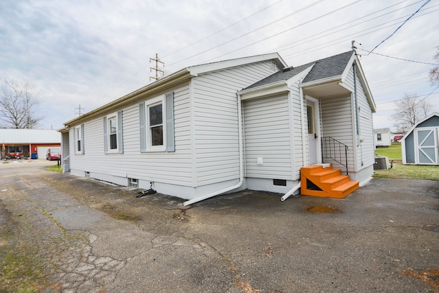 view of side of home featuring central AC unit