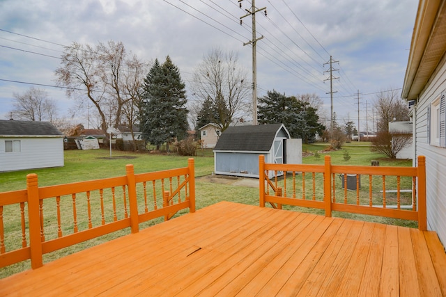 wooden deck featuring a yard and a storage unit