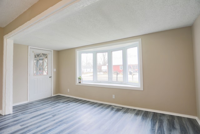 entryway featuring a textured ceiling and dark hardwood / wood-style flooring