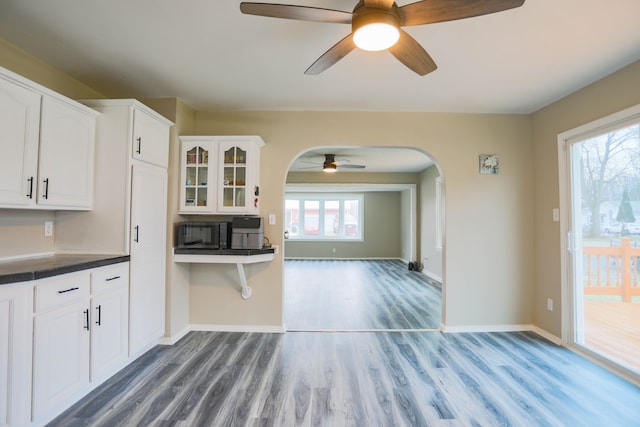 kitchen featuring white cabinetry, ceiling fan, and wood-type flooring