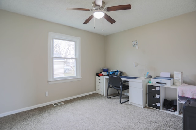 office space featuring light carpet and ceiling fan