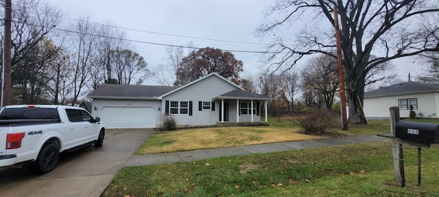 ranch-style house featuring a garage and a front lawn