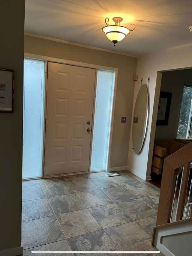 entryway featuring ornamental molding