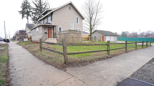 view of side of home featuring a garage and an outdoor structure