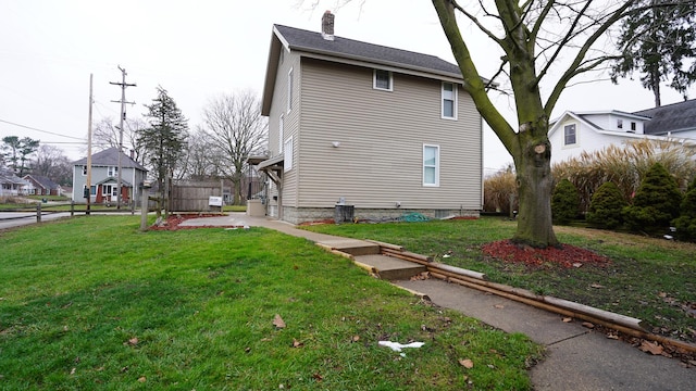 view of side of property with a lawn