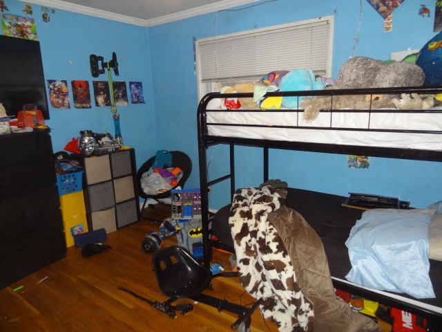 bedroom featuring wood-type flooring and ornamental molding